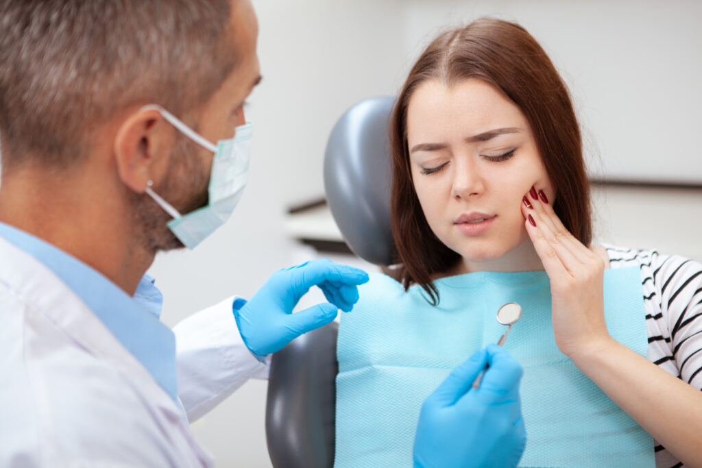 Dentist getting ready to examine a damaged tooth.